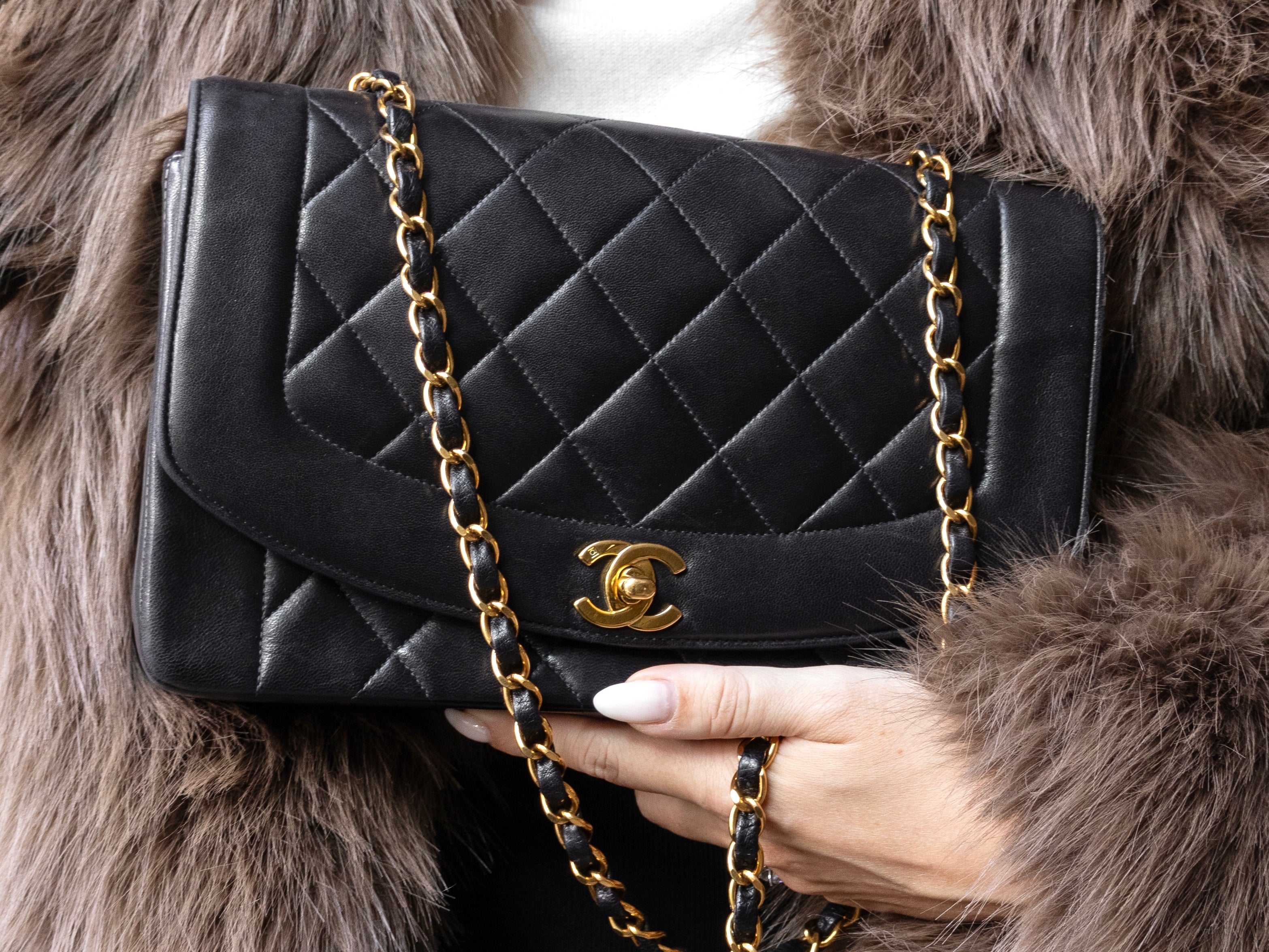 Multiple vintage Chanel bags on cotton bed sheets like a designer bag heaven black lambskin bags with 24k gold hardware authentic